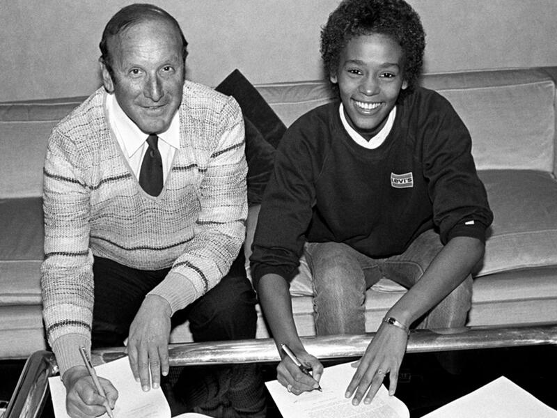 Whitney Houston signing her first recording contract alongside executive Clive Davis at Arista Records in New York City, April 1983