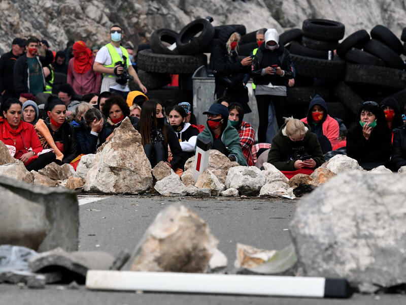 Demonstrators gather at a barricade set up to block access roads to the historic city of Cetinje during a protest against the inauguration of the new head of the Serbian Orthodox Church on September 5, 2021 in Montenegro. The new head of the Serbian Orthodox Church in Montenegro was inaugurated, arriving by helicopter under the protection of police who dispersed protesters with tear gas.