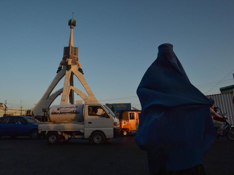 A burqa-clad woman walks along a road in Herat on September 21, 2021. 