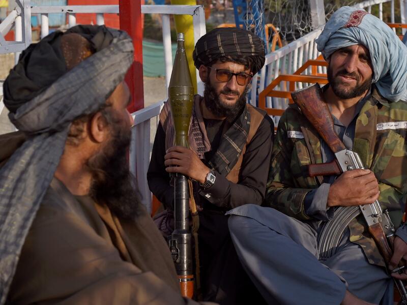 "This is Afghanistan!" a Taliban fighter shouts on the pirate ship ride at a fairground in western Kabul, as his armed comrades cackle and whoop on board the rickety attraction. (Photo by WAKIL KOHSAR / AFP) / TO GO WITH: AFGHANISTAN-CONFLICT-FAIRGROUND, SCENE BY JAMES EDGAR - TO GO WITH: Afghanistan-conflict-fairground, SCENE by James EDGAR