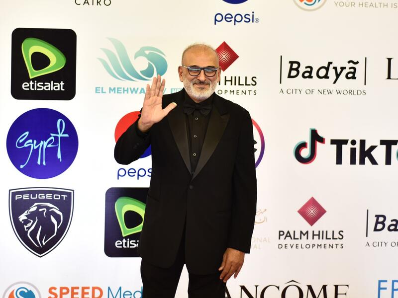 Syrian actor Jamal Suleiman poses on the red carpet during the opening of the 43rd edition of the Cairo International Film Festival (CIFF) at the Cairo Opera House in the Egyptian capital on November 26, 2021. (Photo by Sayed HASAN / AFP)