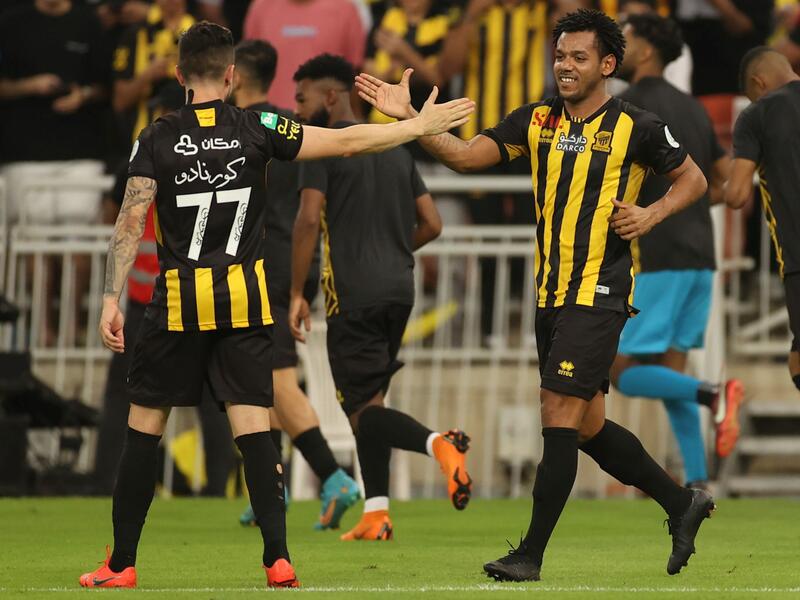 Ittihad's forward Romarinho (R) celebrates his goal with a teammate during a Saudi Pro League football match between al-Ittihad and al-Hilal at the King Abdullah Sports City in Jeddah on May 23, 2022. (Photo by AFP)