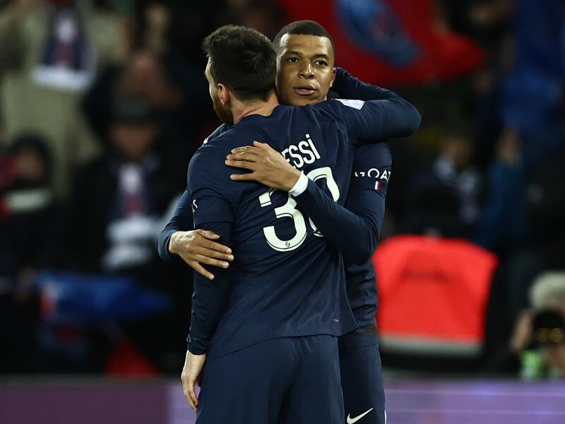 Paris Saint-Germain's Argentine forward Lionel Messi is congratulated by Paris Saint-Germain's French forward Kylian Mbappe after scoring his team's third goal during the French L1 football match between Paris Saint-Germain (PSG) and Lens (RCL) at the Parc des Princes in Paris, on April 15, 2023. (Photo by Anne-Christine POUJOULAT / AFP)