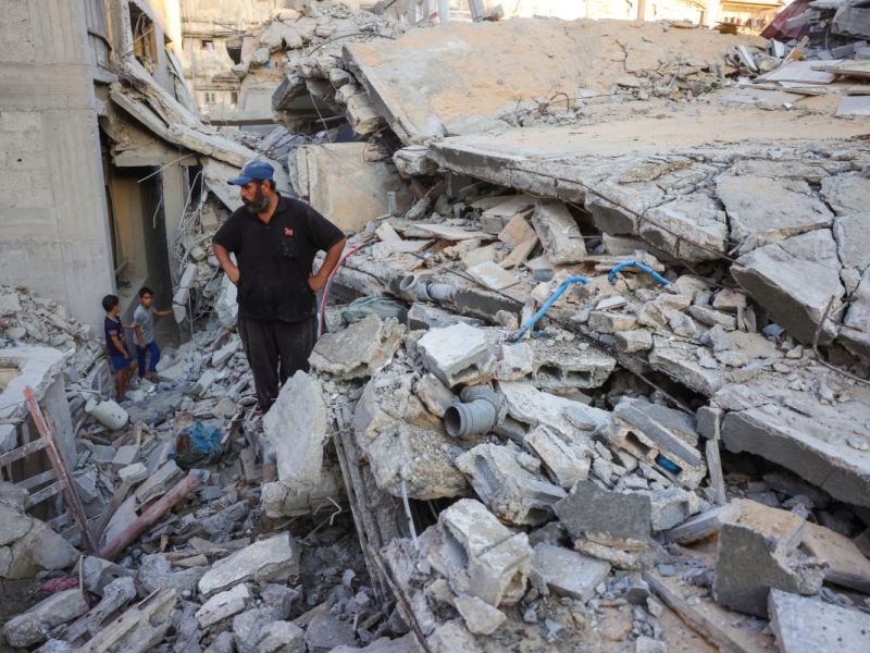 A man and children look at the rubble of a house destroyed in an Israeli strike in Khan Yunis, in the southern Gaza Strip, on October 29, 2025. Photo by BASHAR TALEB / AFP ceasefire
