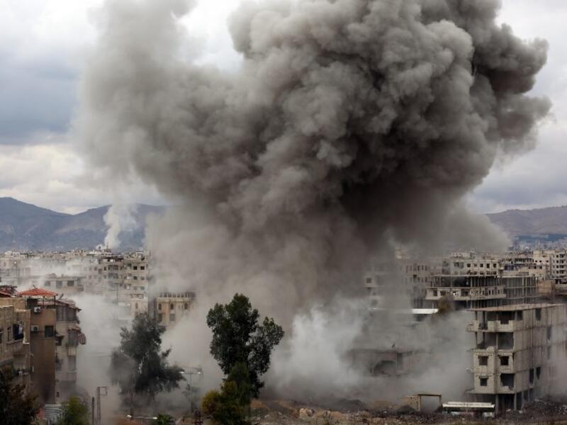 Smoke billows following Syrian government bombardments on Kafr Batna, in the besieged Eastern Ghouta region on the outskirts of the capital Damascus on Feb. 22, 2018. 
(AMER ALMOHIBANY / AFP)