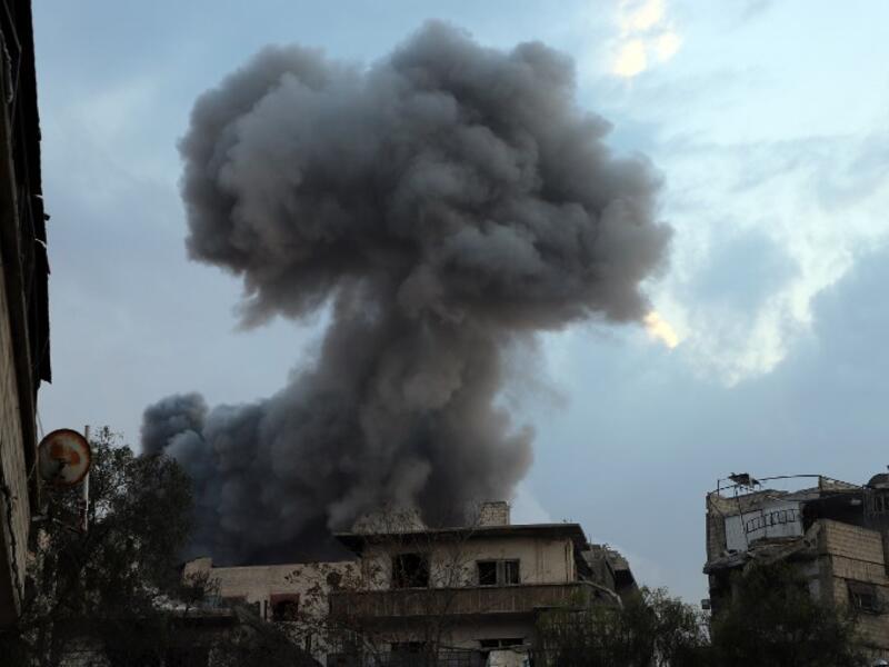 Smoke billows following a regime air strike on the rebel-held town of Haza, in the besieged Eastern Ghouta region on the outskirts of the capital Damascus, on Feb. 23, 2018. Syrian regime air strikes and artillery fire hit the rebel-held enclave of Eastern Ghouta for a sixth straight day killing 32 civilians, as the world struggled to reach a deal to stop the carnage.
(AMER ALMOHIBANY / AFP)