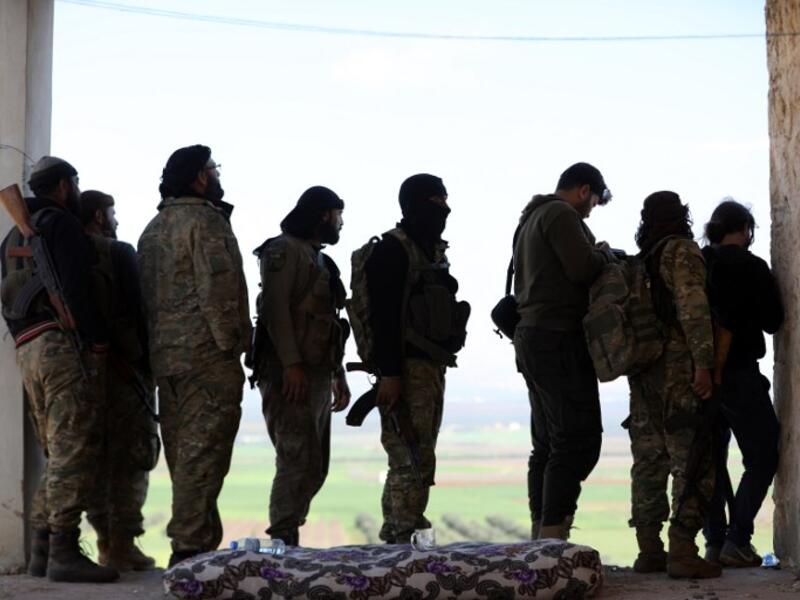 Turkish-backed Syrian rebels gather in the town of Jalamah on the Syrian-Turkish border on Mar. 12, 2018. 
(OMAR HAJ KADOUR / AFP)
