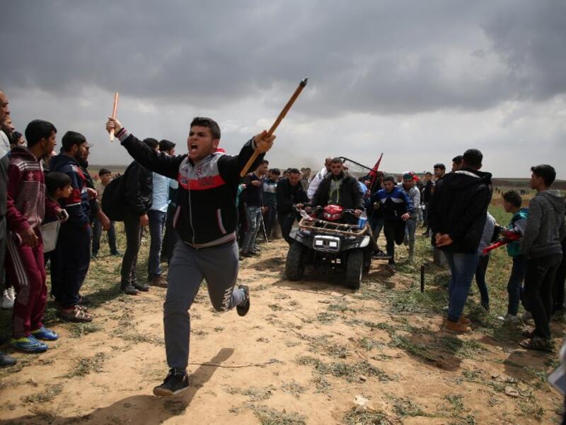 A picture taken on Mar. 30, 2018 shows a Palestinian youth being carried on an all-terrain vehicle after being injured during a demonstration near the border with Israel east of Jabalia in the Gaza strip commemorating Land Day. (MOHAMMED ABED / AFP)