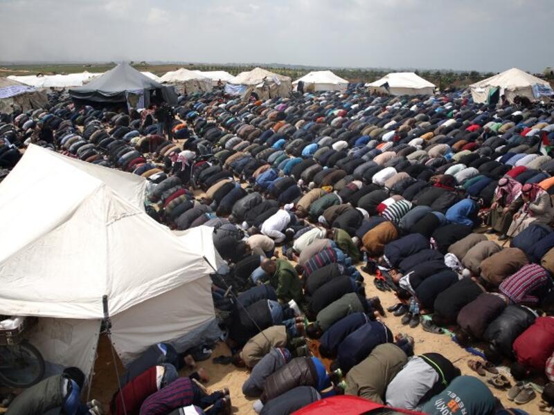 Muslim worshipers perform Friday noon prayers during a tent city protest near the border with Israel east of Jabalia to commemorate Land Day on Mar. 30, 2018. Land Day marks the killing of six Arab Israelis during 1976 demonstrations against Israeli confiscations of Arab land.
(Mohammed ABED / AFP)