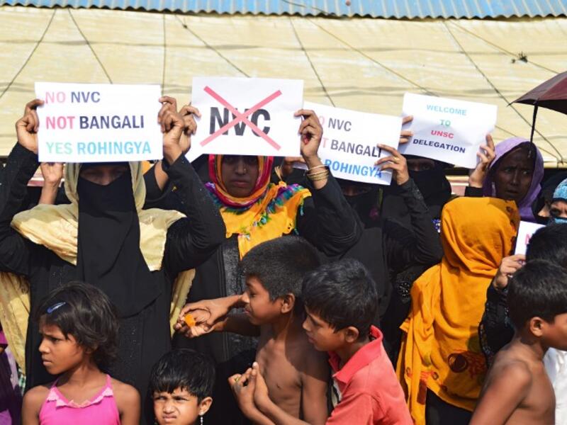 Rohingya refugees women hold placards to members of United nations Security Council team during their visit to Kutupalong refugee camp in Bangladesh's Ukhia's district on 29 April 2018.  Sam Jahan/AFP