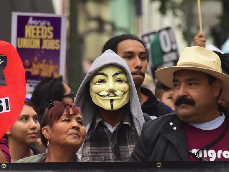 Demonstrators march through the city during May Day protests in Los Angeles, California on May 1, 2018 / AFP
