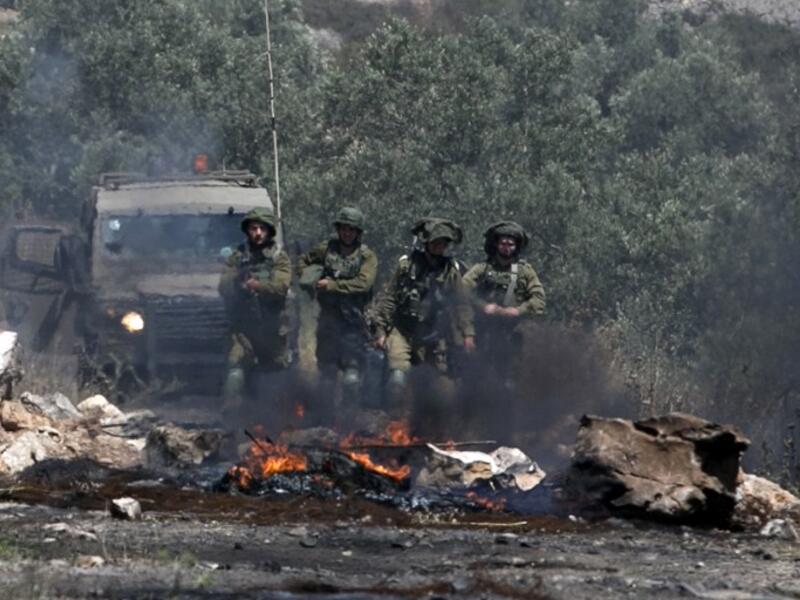 Israeli soldiers take position as Palestinian protesters clash with Israeli forces during a weekly demonstration against the expropriation of Palestinian land by Israel in the village of Kfar Qaddum, near Nablus in the occupied West Bank, on May 11, 2018. 
(JAAFAR ASHTIYEH / AFP)