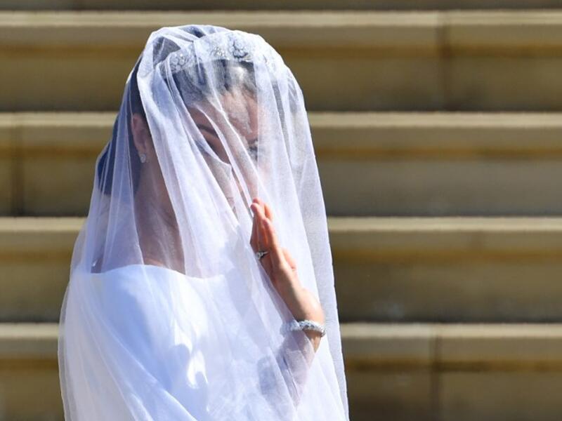 US actress Meghan Markle waves as she arrives for the wedding ceremony to marry Britain's Prince Harry, Duke of Sussex, at St George's Chapel, Windsor Castle, in Windsor, on May 19, 2018. 
Ben STANSALL/ AFP