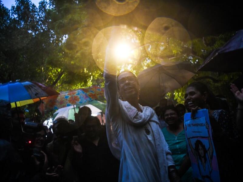 Indian members and supporters of the lesbian, gay, bisexual, transgender (LGBT) community celebrate the Supreme Court decision to strike down a colonial-era ban on gay sex, during heavy rainfall in New Delhi on September 6, 2018. 
CHANDAN KHANNA / AFP