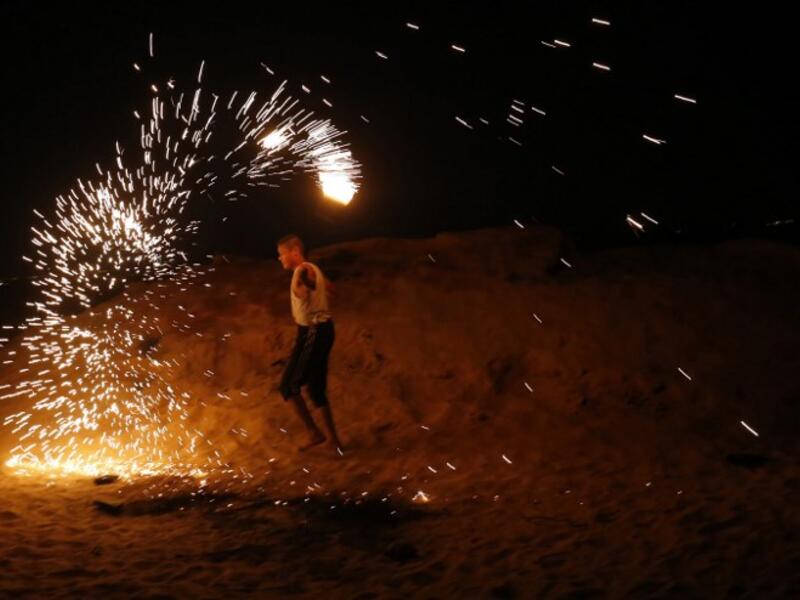 A Palestinian protester from a group calling themselves the "night confusion units" waves a sparkler near the Gaza-Israel border east of Rafah in the southern Gaza Strip, on September 26, 2018. 
SAID KHATIB / AFP
