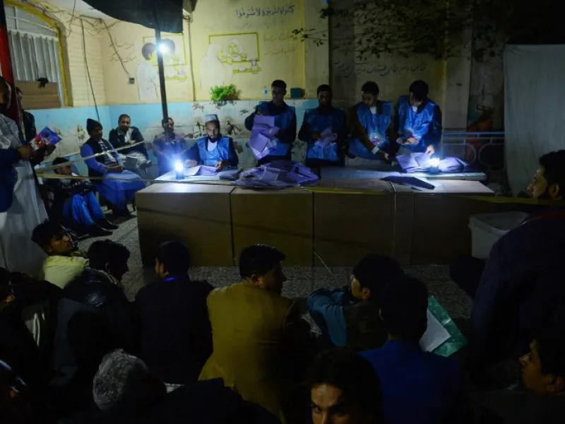 In this photo taken on October 20, 2018, Afghan Independent Election Commission (IEC) officials count ballot papers at a polling centre for the country's legislative election in Herat province. 
HOSHANG HASHIMI / AFP