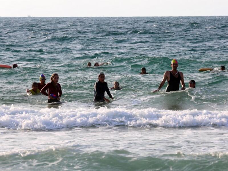 On one of the world's most polluted beaches, 30 young Palestinians dive head first into the sea off the coast of Gaza, their minds filled with dreams of Olympic glory. (SAID KHATIB / AFP)