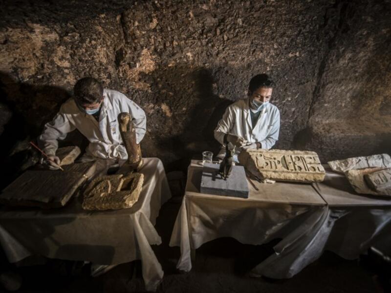 Egyptian archaeologist work on monuments during a new discovery made by an Egyptian archaeological mission. (KHALED DESOUKI / AFP)