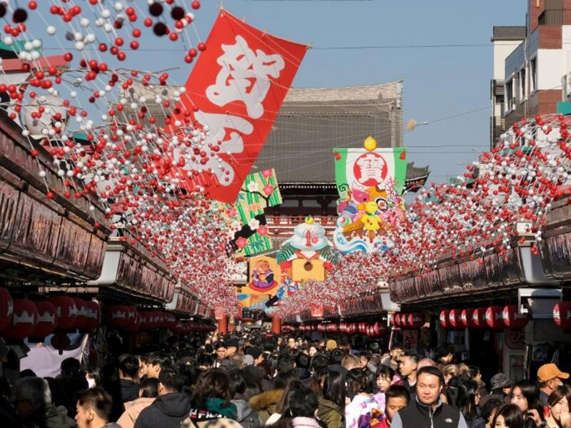 Visitors walk underneath New Year's Day decorations along the Nakamise shopping alley, the front approach to Sensoji Temple, in Tokyo on December 27, 2018. 
Kazuhiro NOGI / AFP
