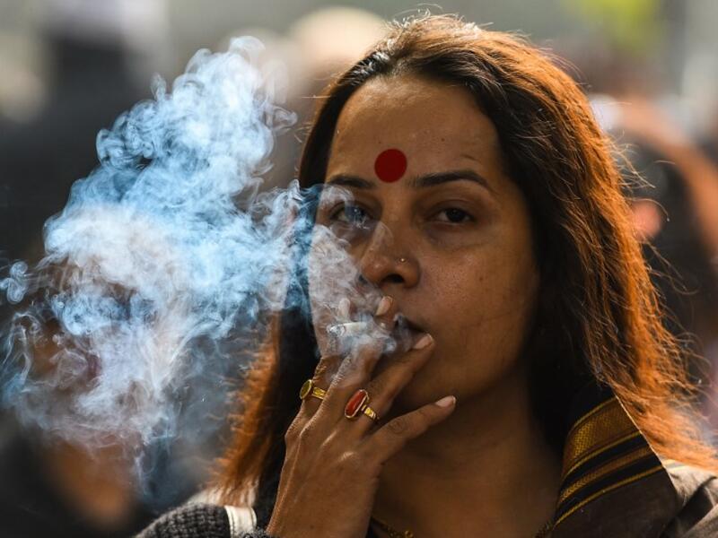 A member of the Indian transgender community smokes a cigarette as she protests against the Transgender Persons (Protection of Rights) Bill in New Delhi on December 28, 2018. 
CHANDAN KHANNA / AFP