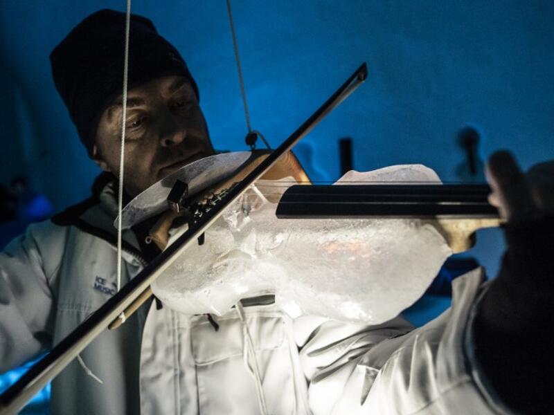 A musician performs with an ice double bass during a concert in the "Ice Dome" on Presena Galcier, Tonale Pass, near Trento in northern Italy on January 17, 2018.
MARCO BERTORELLO / AFP