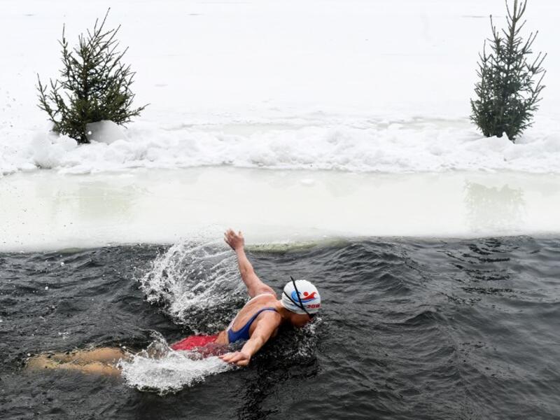 Natalya Seraya, the founder and chief of Moscow's ice swimming club "Walruses of the Capital", swims in a strip of water cut in the ice by the bank of the Moscow River on February 3, 2019. 
Kirill KUDRYAVTSEV / AFP