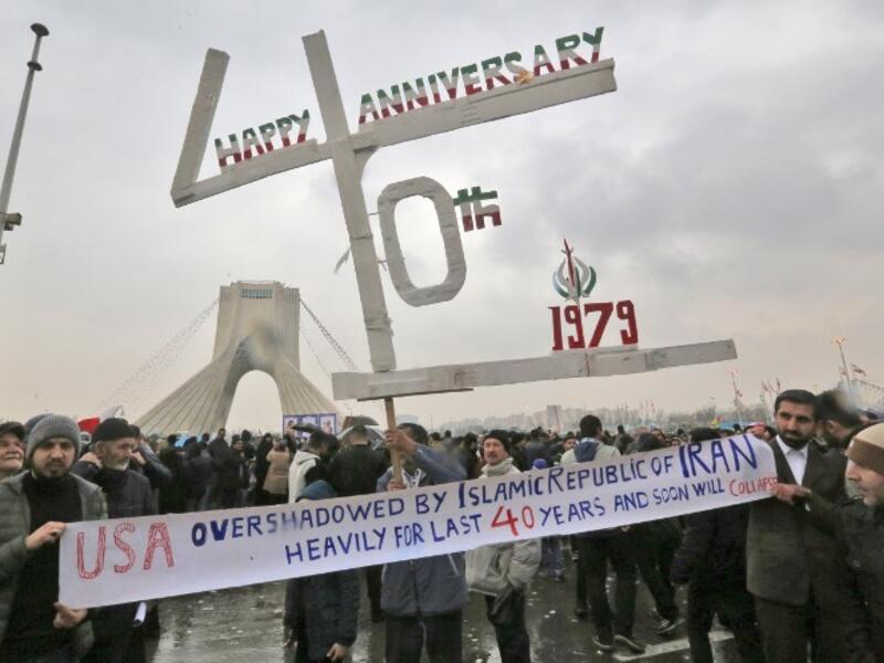 Iranians pose for a picture as they assemble with others in the capital Tehran's Azadi (Freedom) square on February 11, 2019 during a ceremony celebrating the 40th anniversary of Islamic Revolution. 
ATTA KENARE / AFP