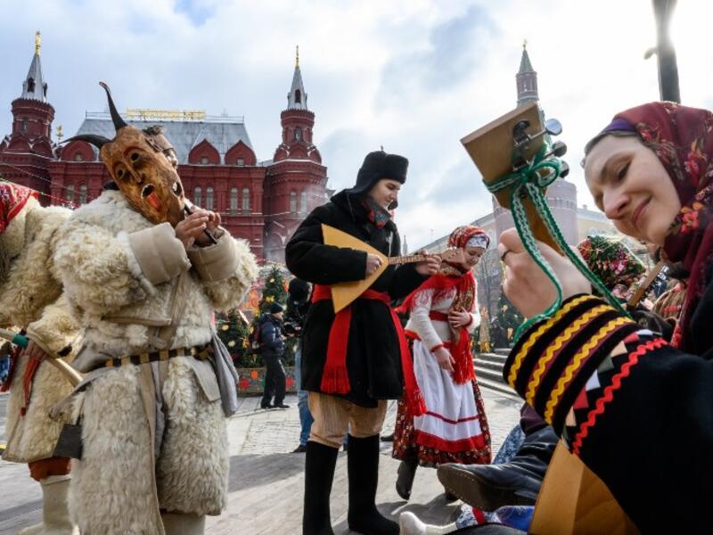 Performers dressed in traditional costumes sing and dance during the Shrovetide spring festival outside the Kremlin in Moscow on March 01, 2019. Mladen ANTONOV / AFP