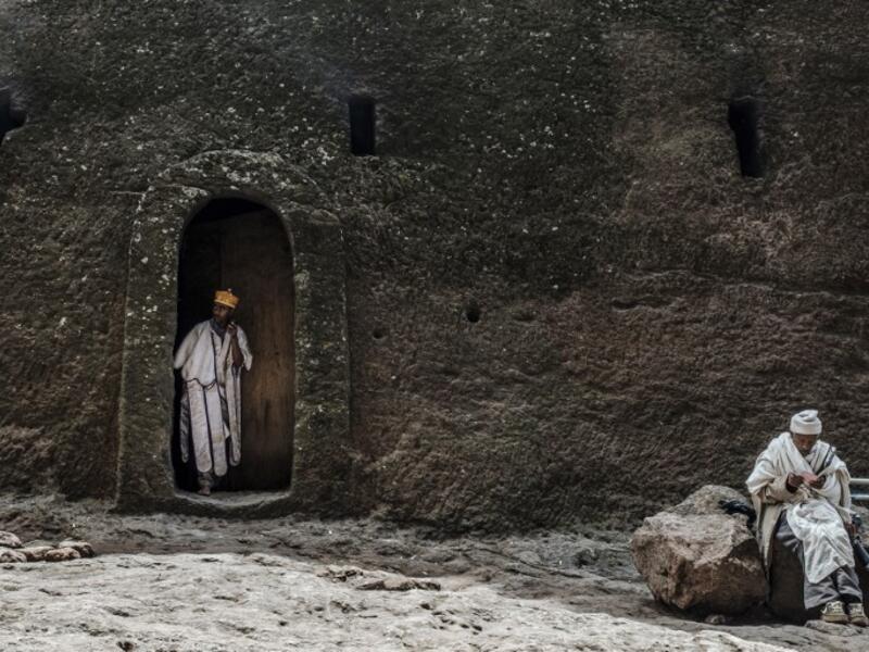 An Ethiopian Orthodox priest steps out of a room of the rock-hewn church of the House of the Saviour of the World in Lalibela, Ethiopia 
EDUARDO SOTERAS / AFP