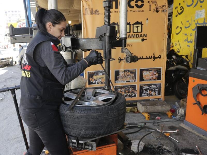 Amina repairs a flat tyre at a car tyre's repair shop in Beirut on March 8, 2019. Amina has been working for 10 years in mechanics, specially in the tyres repair business. She considers it fulfilling as she always dreamt of doing that job.
JOSEPH EID / AFP