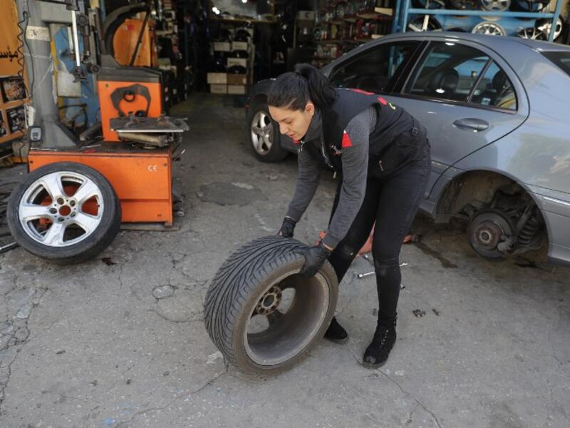 Amina repairs a flat tyre at a car tyre's repair shop in Beirut on March 8, 2019. Amina has been working for 10 years in mechanics, specially in the tyres repair business. She considers it fulfilling as she always dreamt of doing that job.
JOSEPH EID / AFP