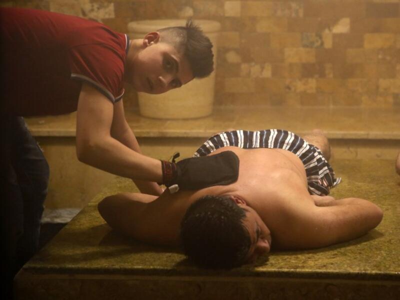 A man receives a body scrub inside the steam room of the first traditional Turkish bath (Hammam) opening in the occupied Palestinian West Bank city of Hebron on March 11, 2019.
HAZEM BADER / AFP