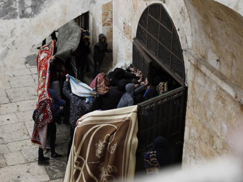 Palestinian protesters break a door of the Golden Gate or Gate of Mercy inside the Al-Aqsa mosques compound in Jerusalem's Old City 
AHMAD GHARABLI / AFP