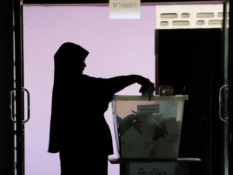 A woman casts her ballot at a polling station in Narathiwat on March 24, 2019 during Thailand's general election. 
(Madaree TOHLALA / AFP)
