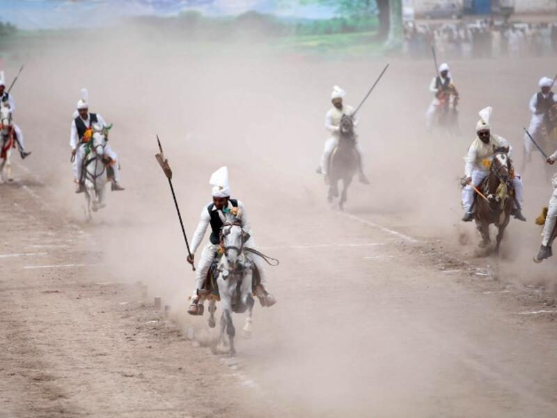  Pakistani horse riders during an attempt for a Guinness World Record for tent pegging in Khanewal district in Punjab province.
SS MIRZA / AFP