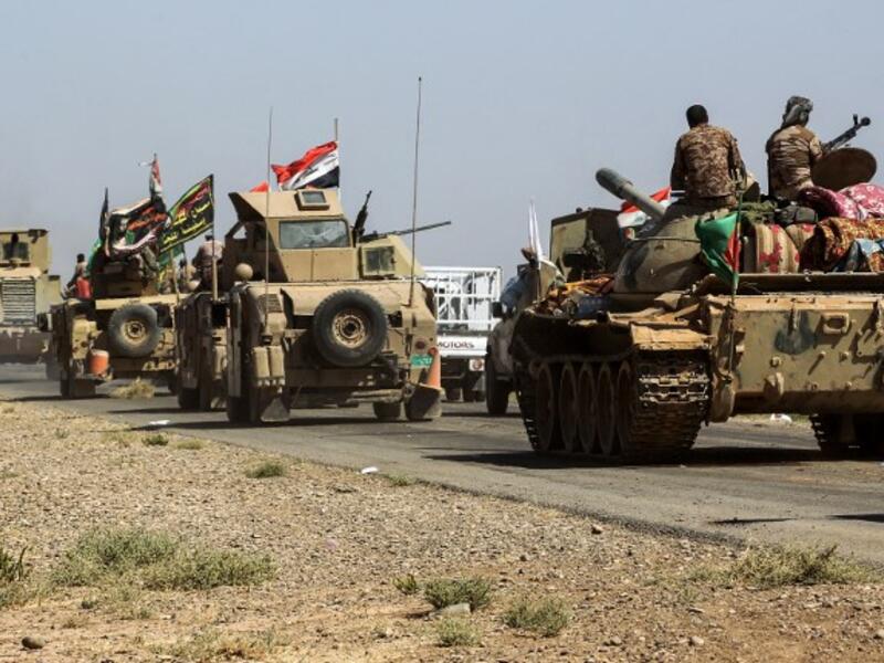 Tanks and vehicles of the combined Iraqi forces and Hashed al-Shaabi (Popular Mobilization) paramilitaries are seen on the advance towards villages between the northern Iraqi cities of Hawija and Kirkuk on October 6, 2017, after retaking Hawija from Islamic State (IS) group fighters a day before.
AHMAD AL-RUBAYE / AFP