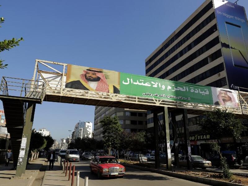 A banner bearing the images of Saudi King Salman bin Abdulaziz (R) and Crown Prince Mohammed bin Salman (L) hangs on a pedestrian crossing bridge in the northern Lebanese port city of Tripoli.

The caption in Arabic says: "firm and moderating leadership".

(JOSEPH EID / AFP)