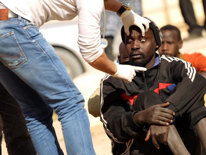 A sub-Saharan migrant undergoes a medical check-up before being repatriated from the Qanfouda detention center, in the southern outskirts of Benghazi, on Dec. 2, 2017. 
(Abdullah DOMA / AFP)