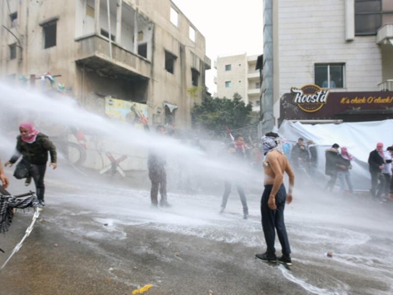 Lebanese security forces use a water hose to disperse protesters during a demonstration outside the US embassy in Awkar, on the outskirts of the Lebanese capital Beirut, on Dec. 10, 2017, to protest against Washington's decision to recognize Jerusalem as the capital of Israel. 
(ANWAR AMRO / AFP)