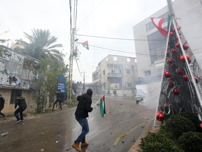 Lebanese security forces fire tear gas to disperse protestors during a demonstration outside the US embassy in Awkar, on the outskirts of the Lebanese capital Beirut, on Dec. 10, 2017, to protest against Washington's decision to recognize Jerusalem as the capital of Israel. 
(ANWAR AMRO / AFP)