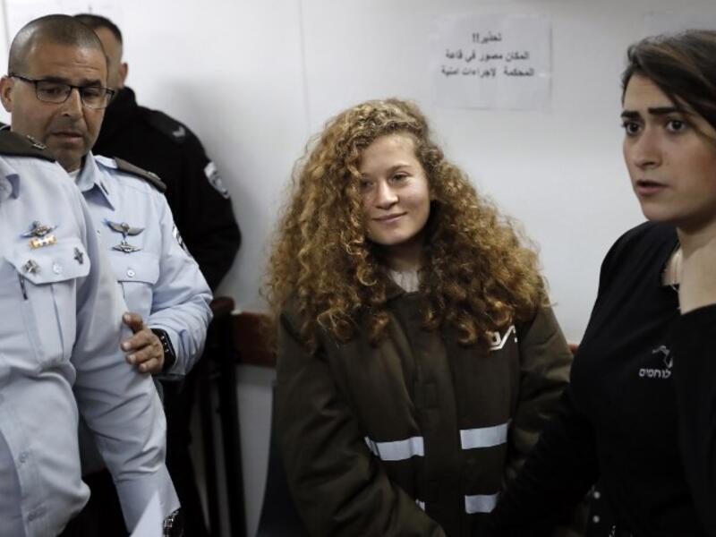 Sixteen-year-old Palestinian Ahed Tamimi (2-R), a well-known campaigner against Israel's occupation, standing for a hearing in the Israeli military court at Ofer military prison in the West Bank village of Betunia on Jan. 15, 2018 (THOMAS COEX / AFP)
