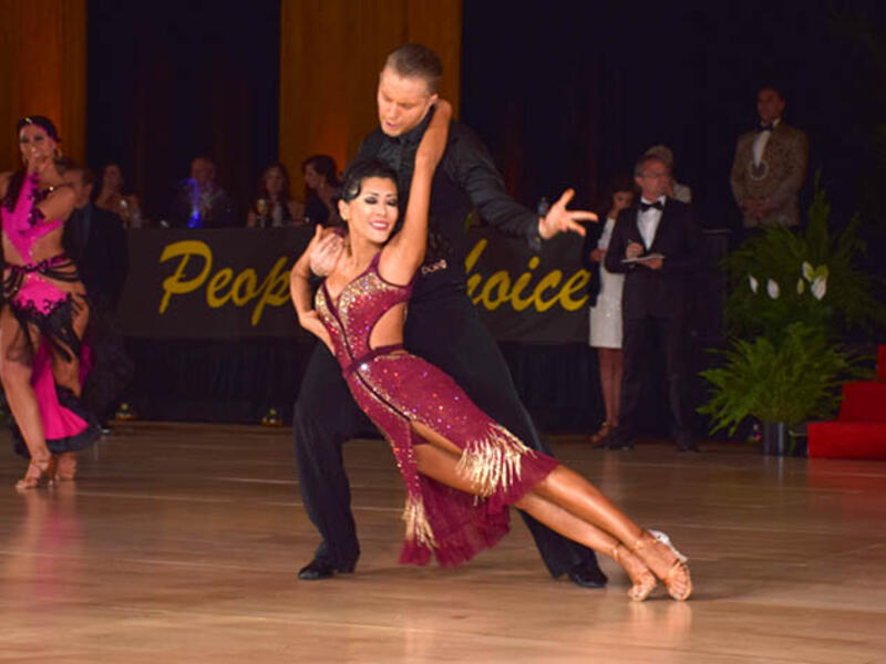 American Rhythm refers to a category of dances in American Style Ballroom competitions. This division includes dances known as the Cha-Cha, Rumba, East Coast Swing, Bolero, and Mambo. (wikidancesport.com)