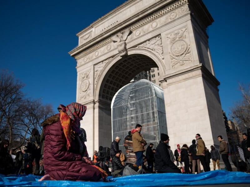 NEW YORK, NY - JAN. 26: Muslims pray following a protest to the mark the one year anniversary of the Trump administration's executive order banning travel into the United States from several Muslim majority countries, in Washington Square Park, New York City. (Drew Angerer/Getty Images/AFP) 