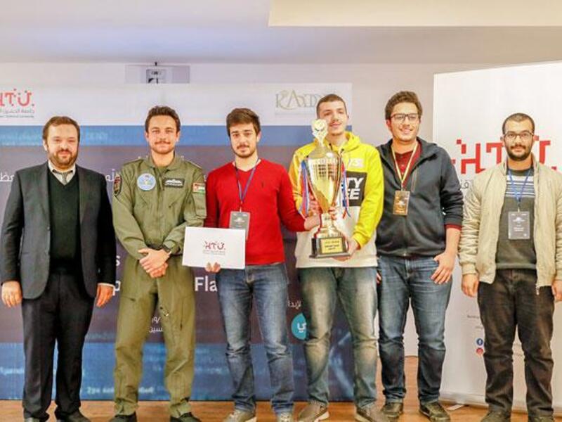 Crown Prince Hussein poses for a photo with the winners of Al Hussein Technical University cybersecurity Hackathon competition, on Wednesday (Petra Photo)