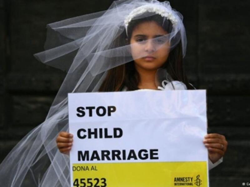 A young actress plays the role of a child bride during a protest organised by Amnesty (AFP/File Photo)	