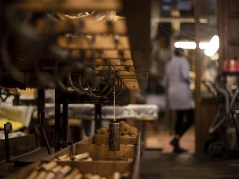 This picture shows a woman at work in the laboratory of Antico setificio Fiorentino ancient silk factory in Florence. 
Tiziana FABI / AFP