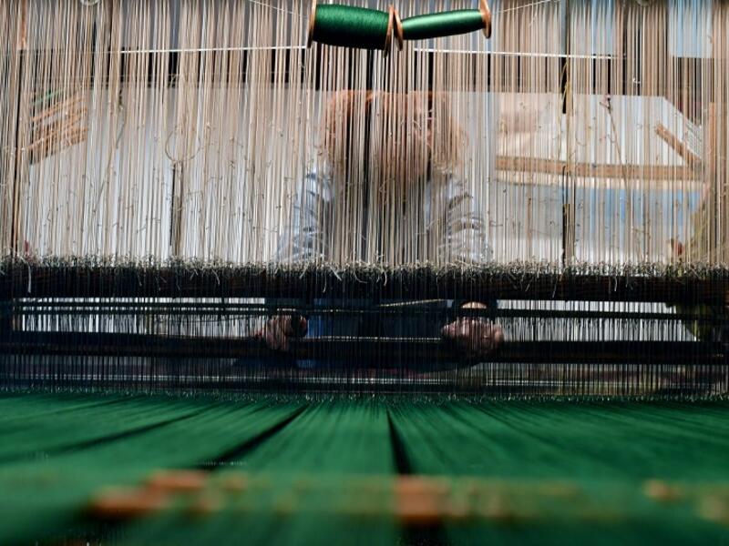 This picture shows a woman at work in the laboratory of Antico setificio Fiorentino ancient silk factory in Florence. 
Tiziana FABI / AFP