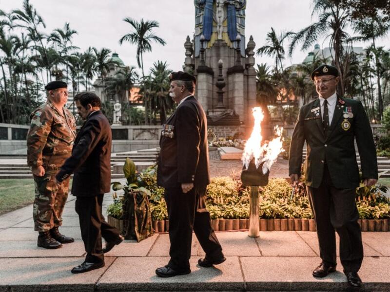 Staff Officers from Defence Reserves of the South African National Defence Force (SANDF) light a gas lamp lit for the Beacon of Light at the Cenotaph in Durban, on November 11, 2018 as part of commemorations marking the 100th anniversary of the 11 November 1918 armistice, ending World War I. 
RAJESH JANTILAL / AFP