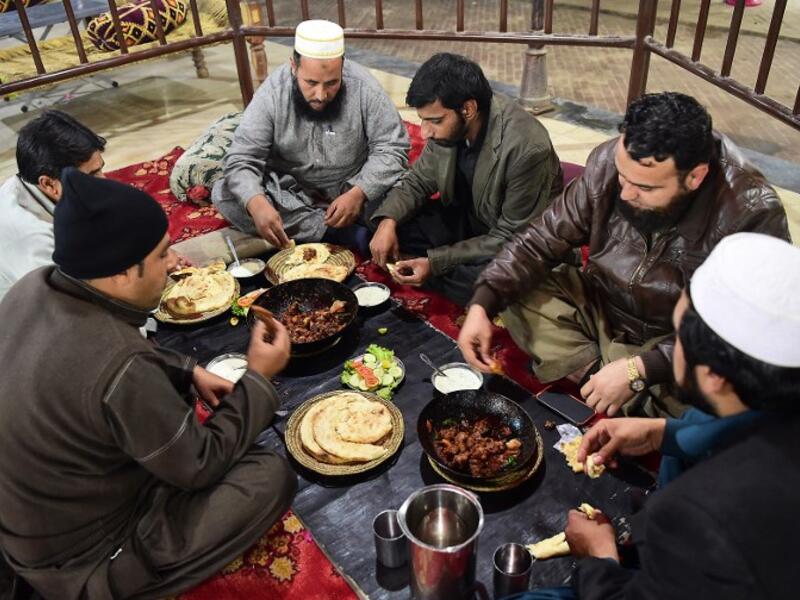  Pakistani customers eat grilled meat at the Charsi (Hashish) Tikka restaurant in Namak Mandi in Peshawar.
ABDUL MAJEED / AFP