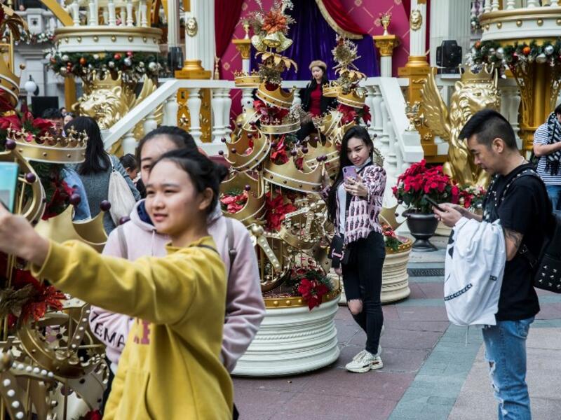 People take photos in front of Christmas decorations on display in the Kowloon district of Hong Kong on December 16, 2018. 
ISAAC LAWRENCE / AFP